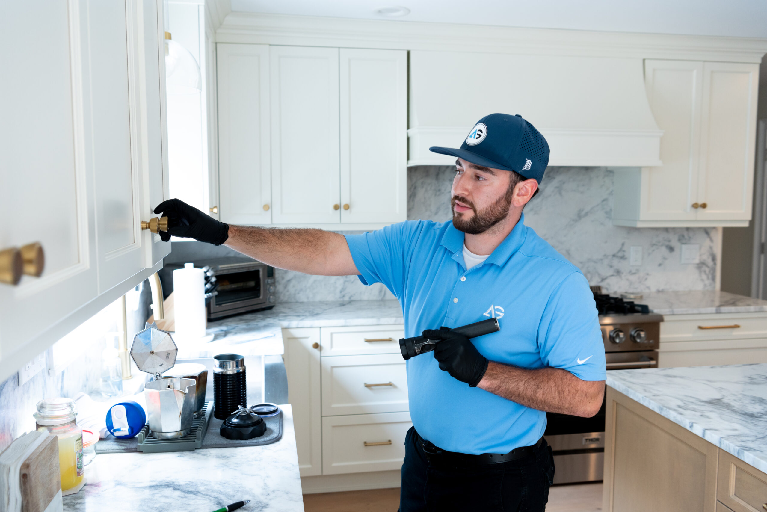 Agile Pest Control technician conducting an interior inspection at a home in Brick, NJ, carefully examining areas for signs of pests while using specialized equipment to ensure a thorough and accurate assessment.