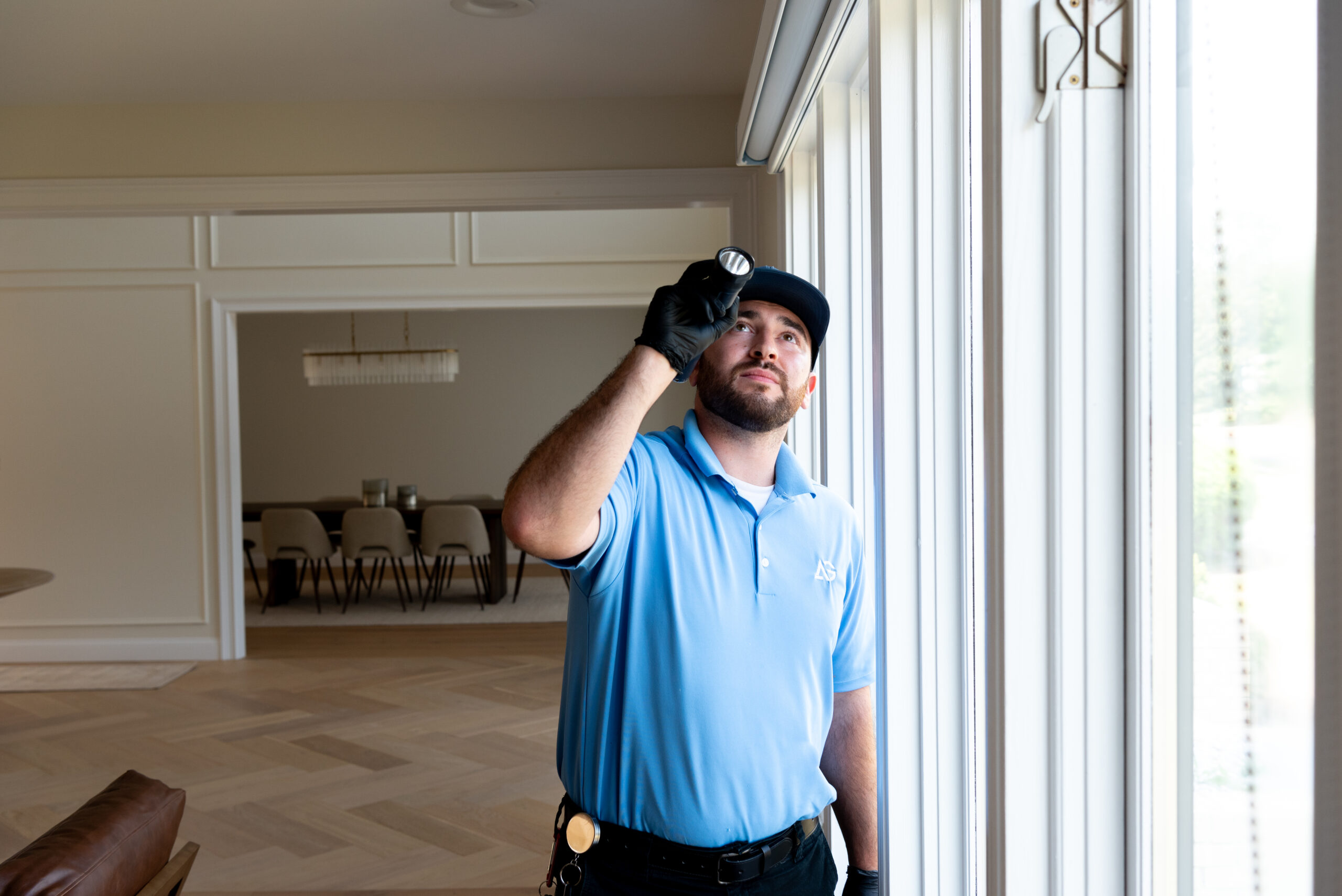 Agile Pest Control technician performing a thorough inspection inside a home in Matawan, NJ, checking for any signs of pest activity.