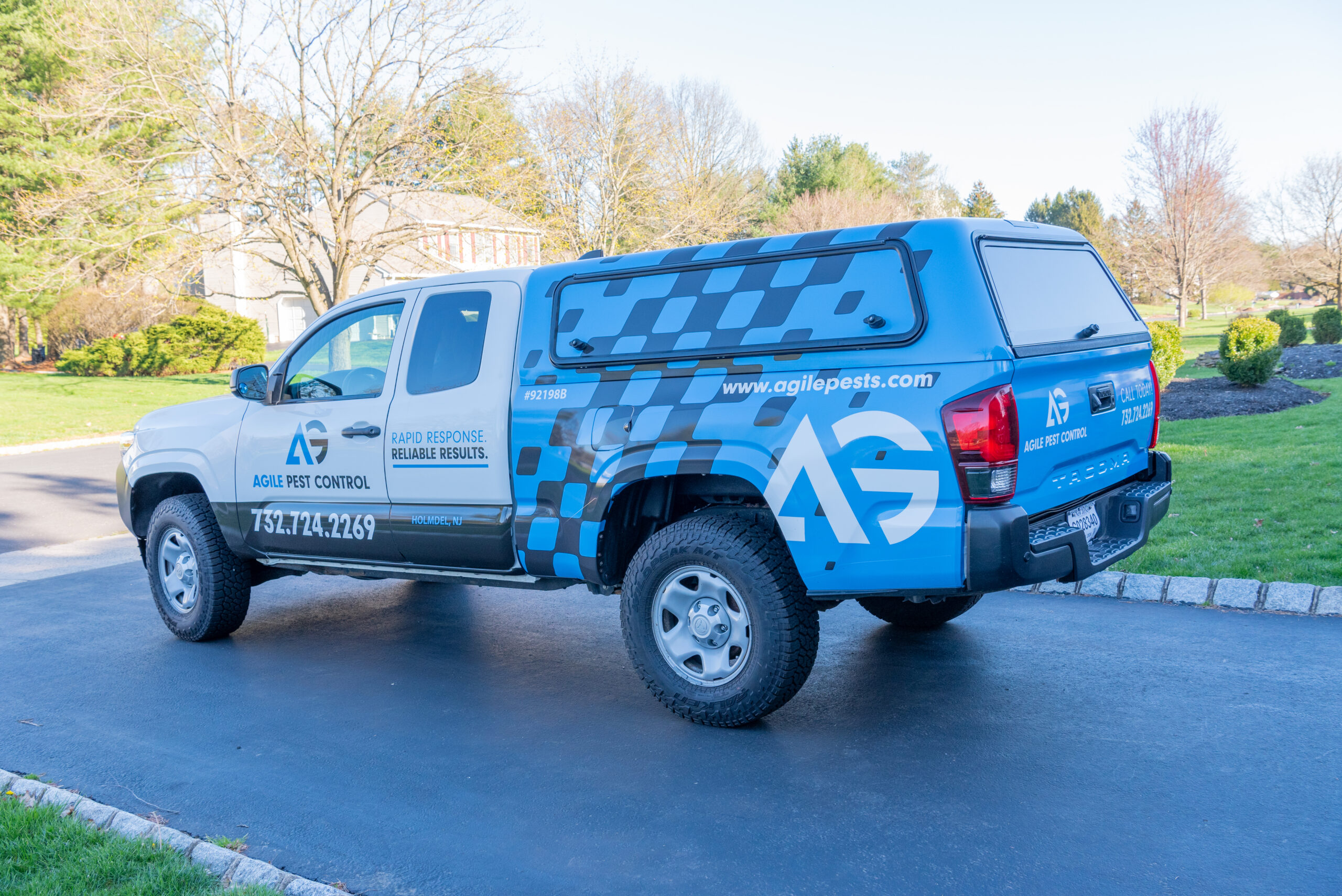 Agile Pest Control truck parked in a driveway in Lincroft, NJ, ready to provide expert rodent control services.