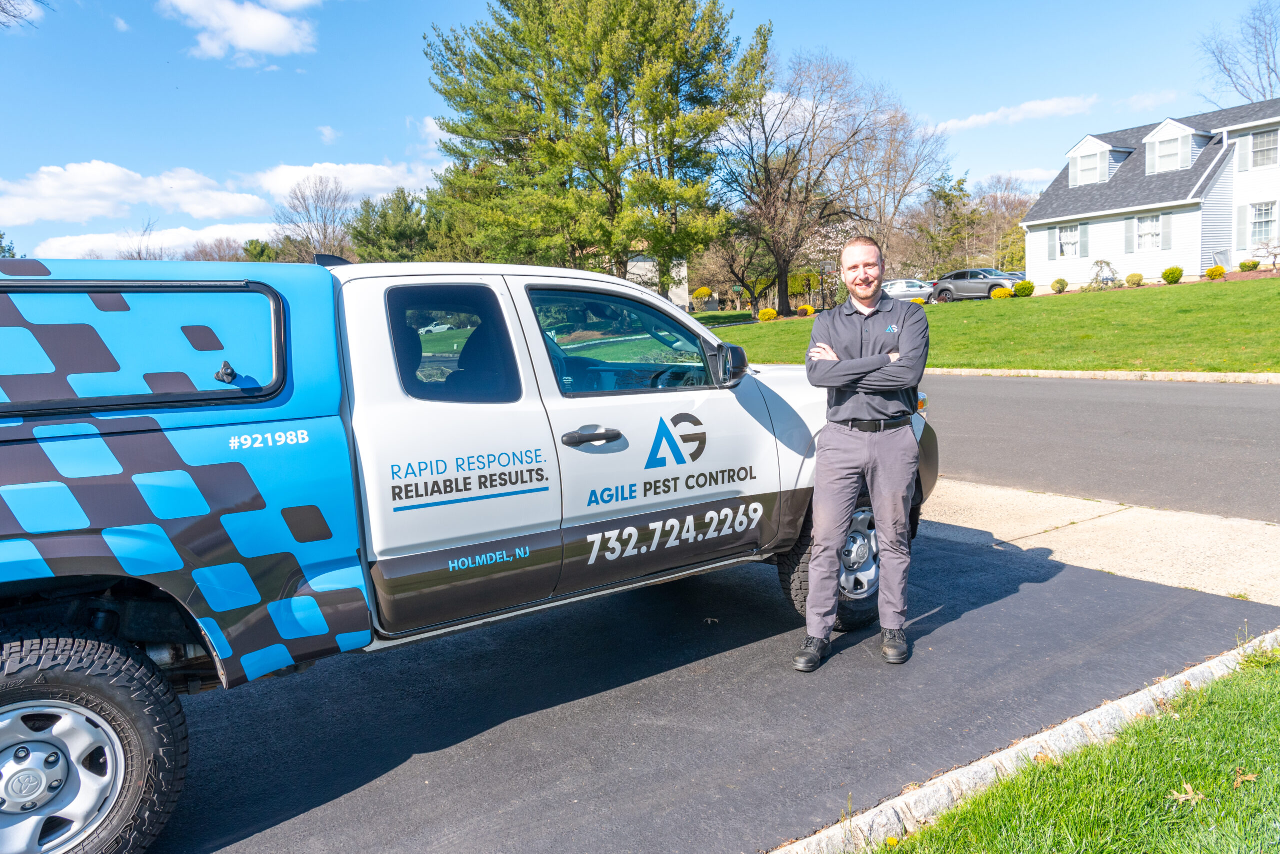 Agile Pest Control technician parked in a customer's driveway in Little Silver, NJ, ready to provide professional rodent control services.