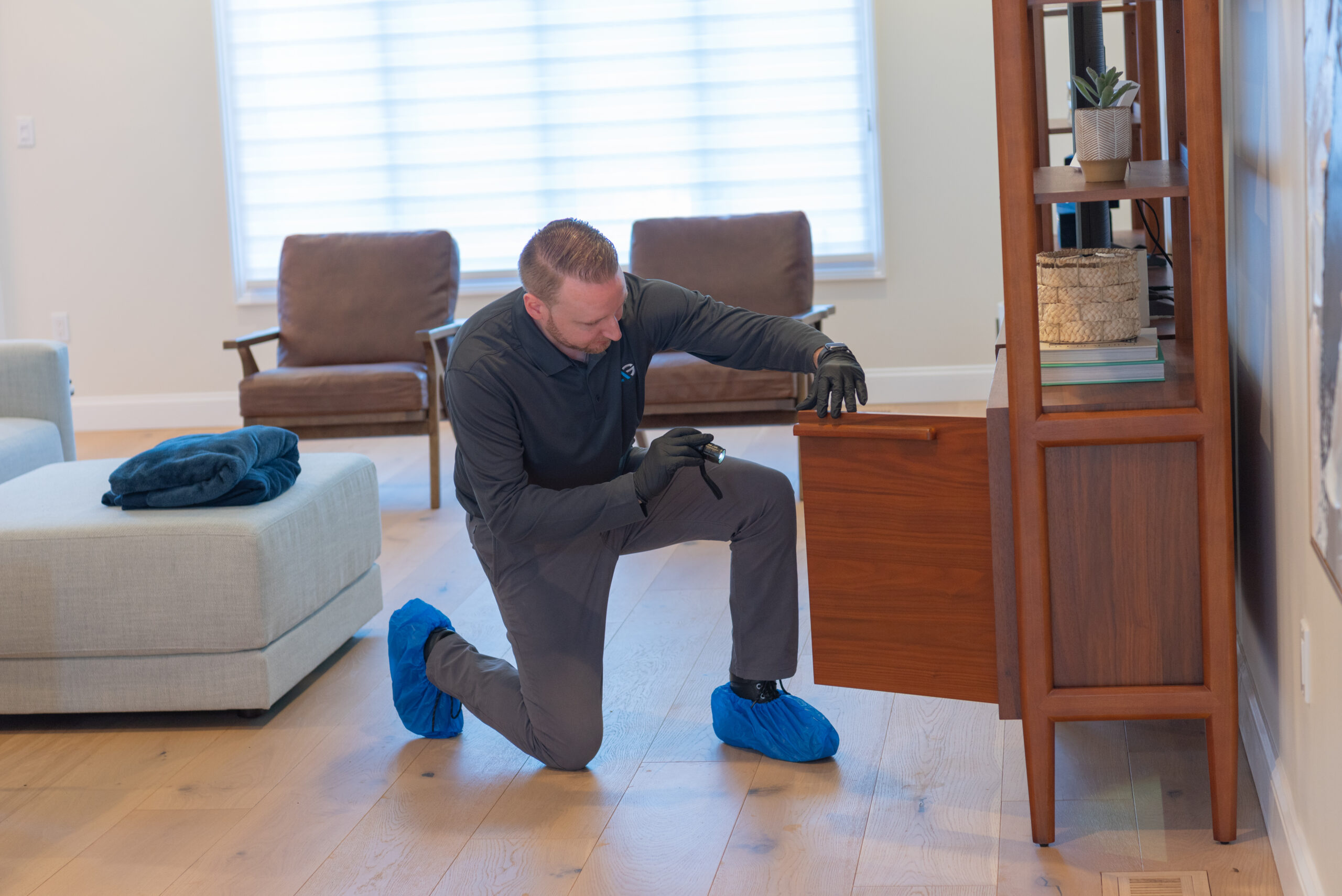 Agile Pest Control technician conducting a detailed inspection at a home in Marlboro, NJ, carefully checking for signs of pest activity to ensure comprehensive protection.