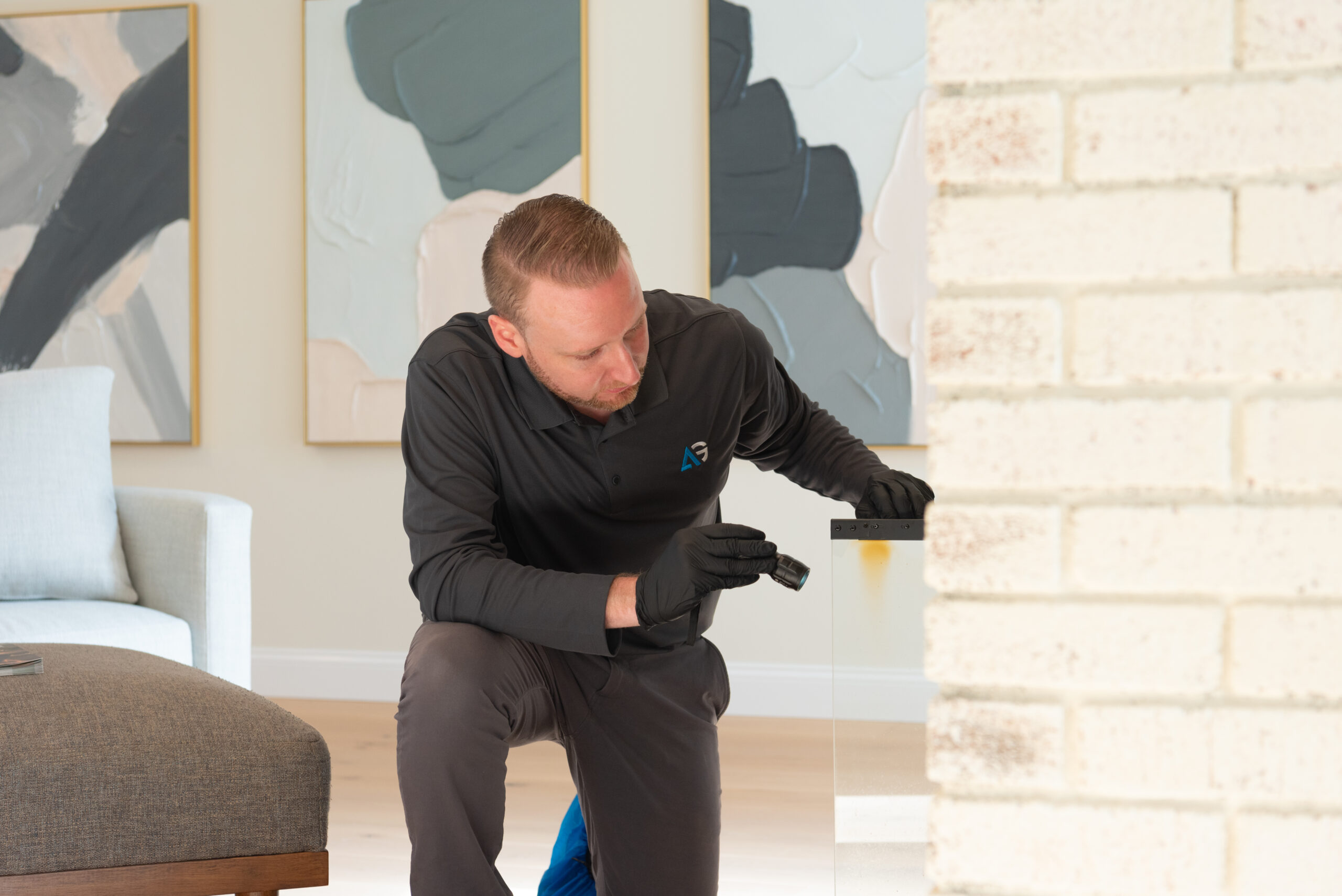 Agile Pest Control technician inspecting the interior of a fireplace for rodent control in a home in Colts Neck, NJ.