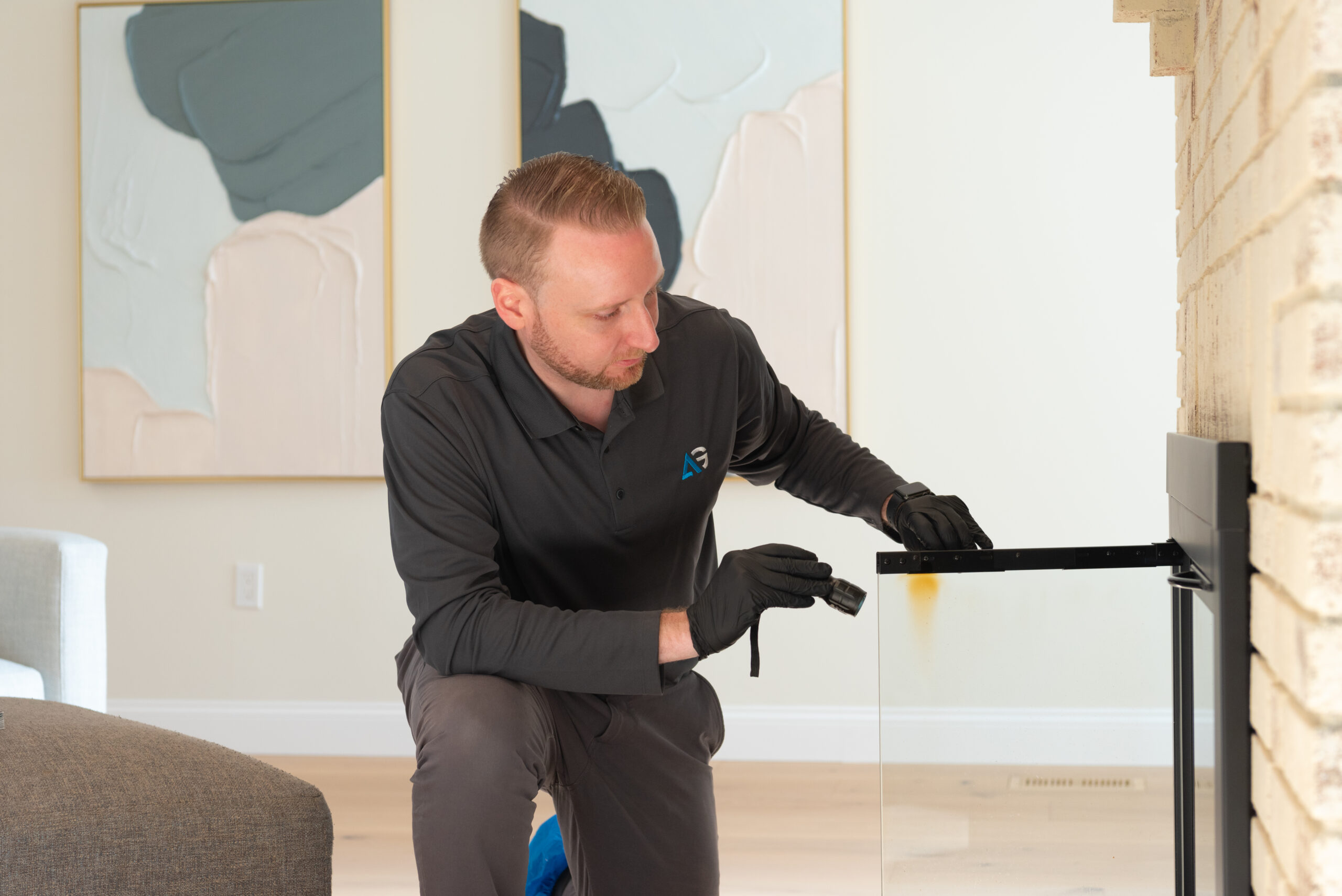 Agile Pest Control technician conducting a thorough inspection in a fireplace for rodent control in a home in Eatontown, NJ