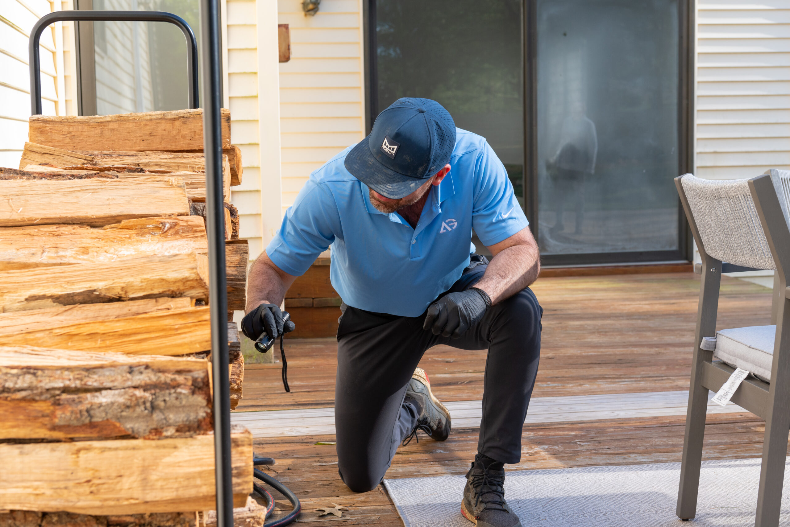 Agile Pest Control technician conducting a thorough inspection for rodent control at a home in Middletown, NJ.