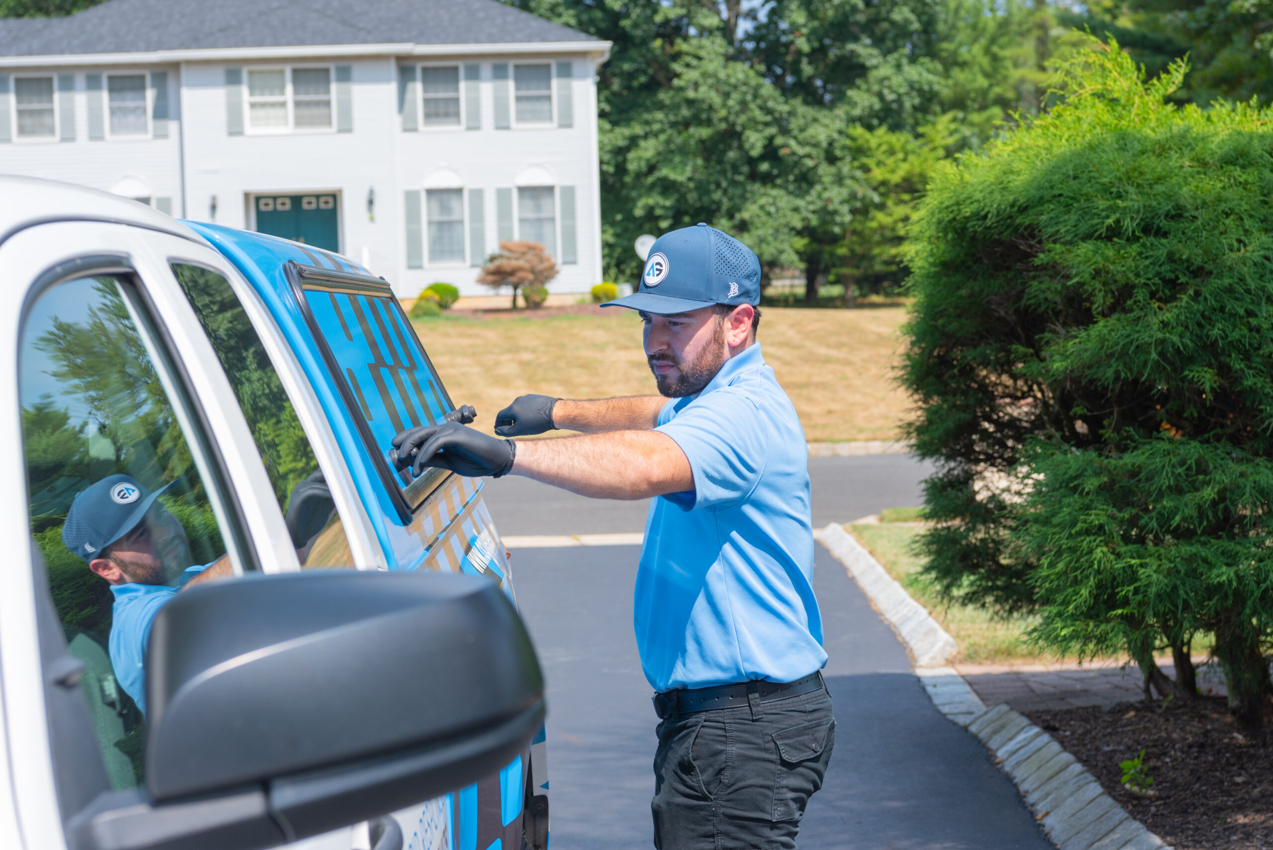 An Agile Pest Control technician sealing entry points around a home for cockroach control in Holmdel, NJ, ensuring the property is protected from future infestations.