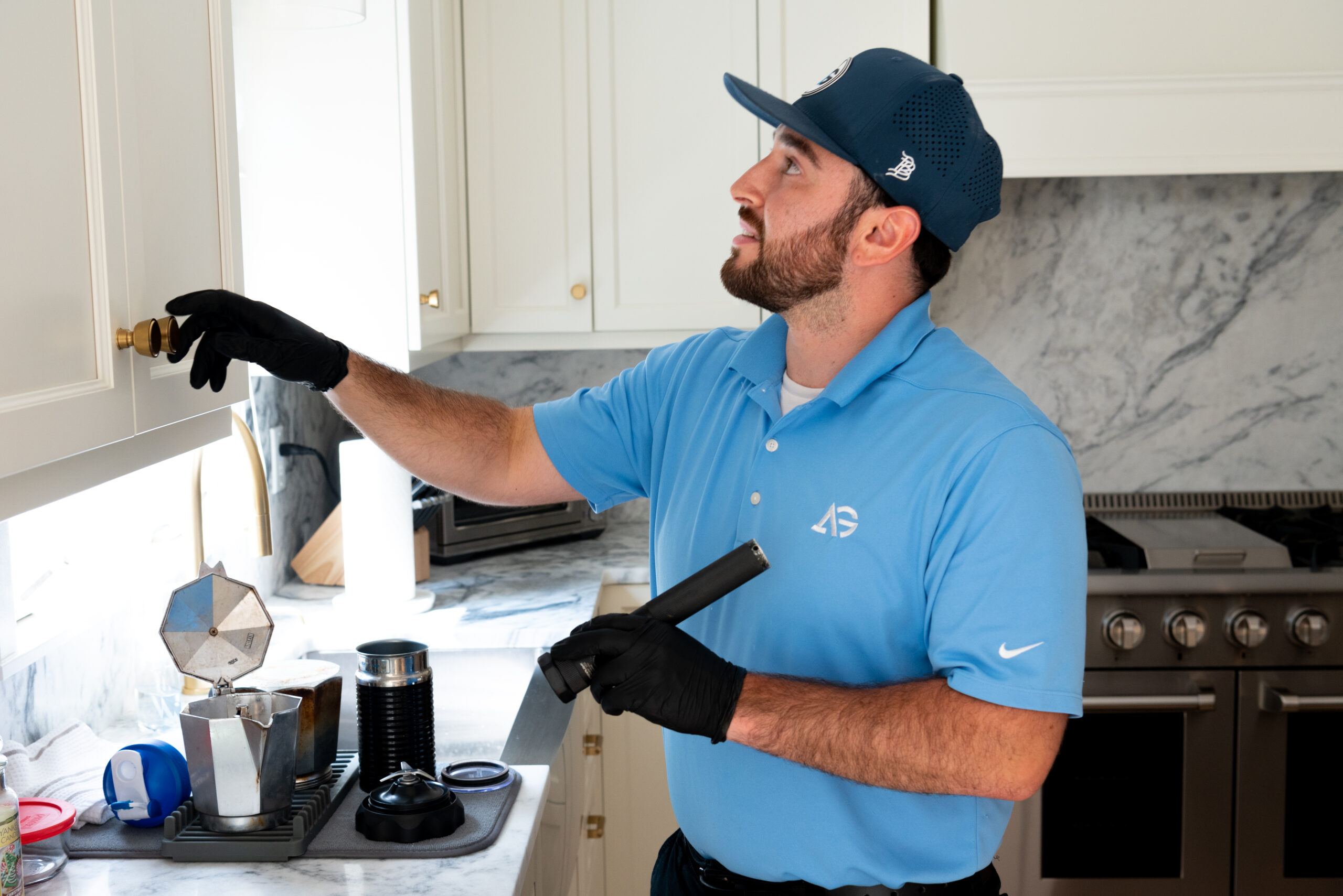 Agile Pest Control technician conducting a thorough bed bug inspection in a Lincroft, NJ home, carefully examining furniture, bedding, and potential hiding spots for signs of infestation.