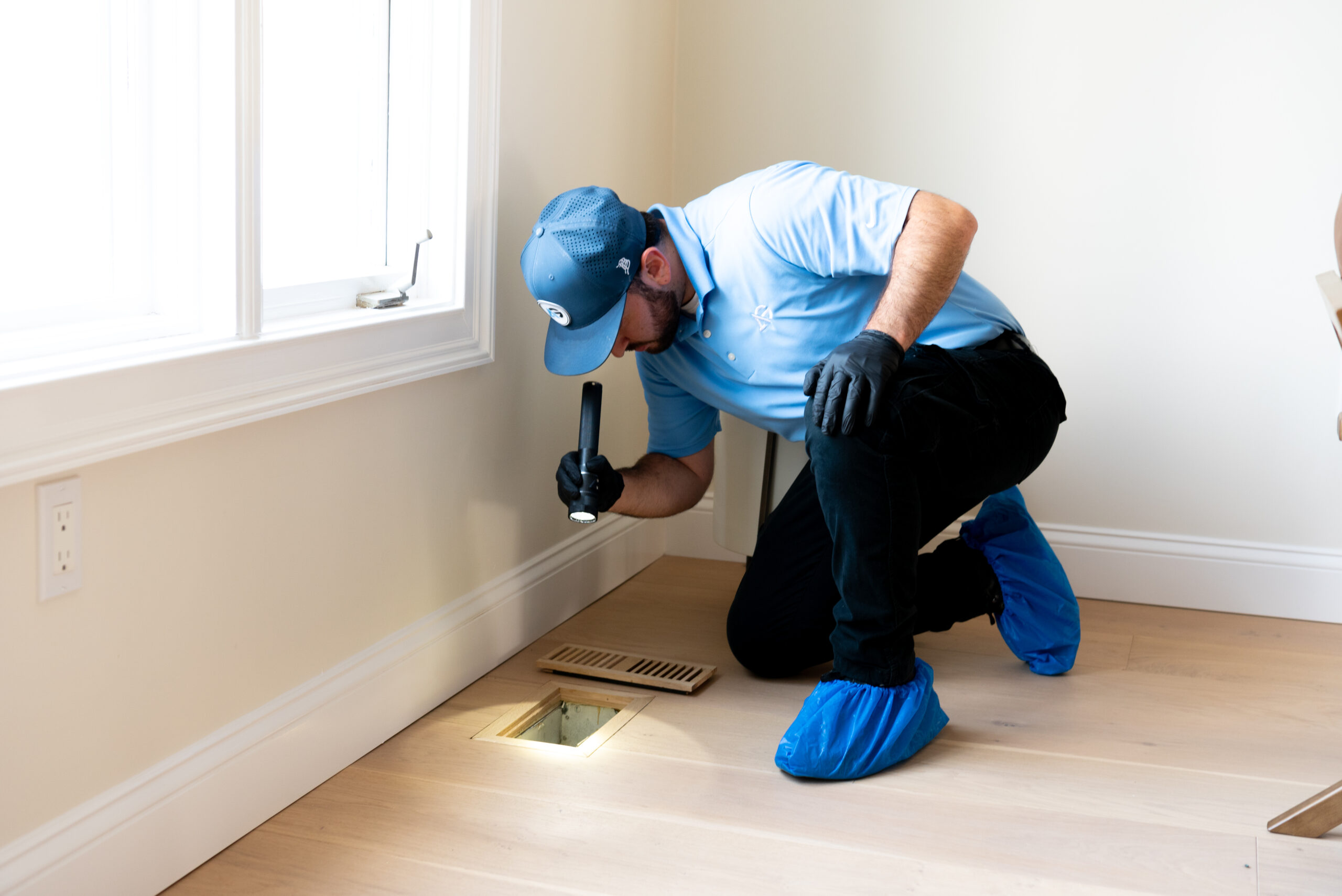 Agile Pest Control technician performing a comprehensive bed bug inspection in a Middletown, NJ home, carefully inspecting furniture and other areas for signs of infestation.