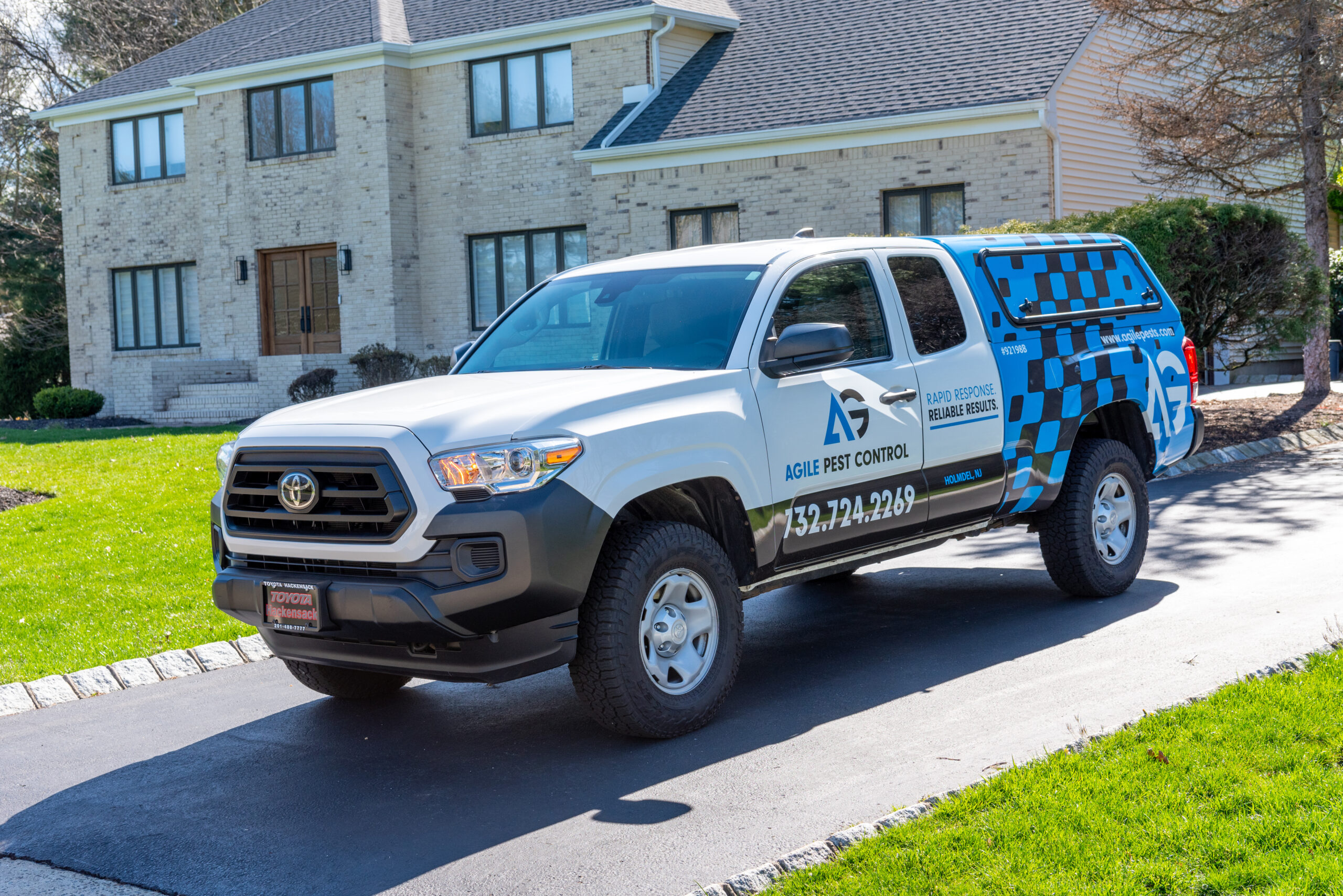 Agile Pest Control truck preparing to provide bed bug control services in Holmdel, NJ, with technicians getting ready to inspect and treat a home for pests.