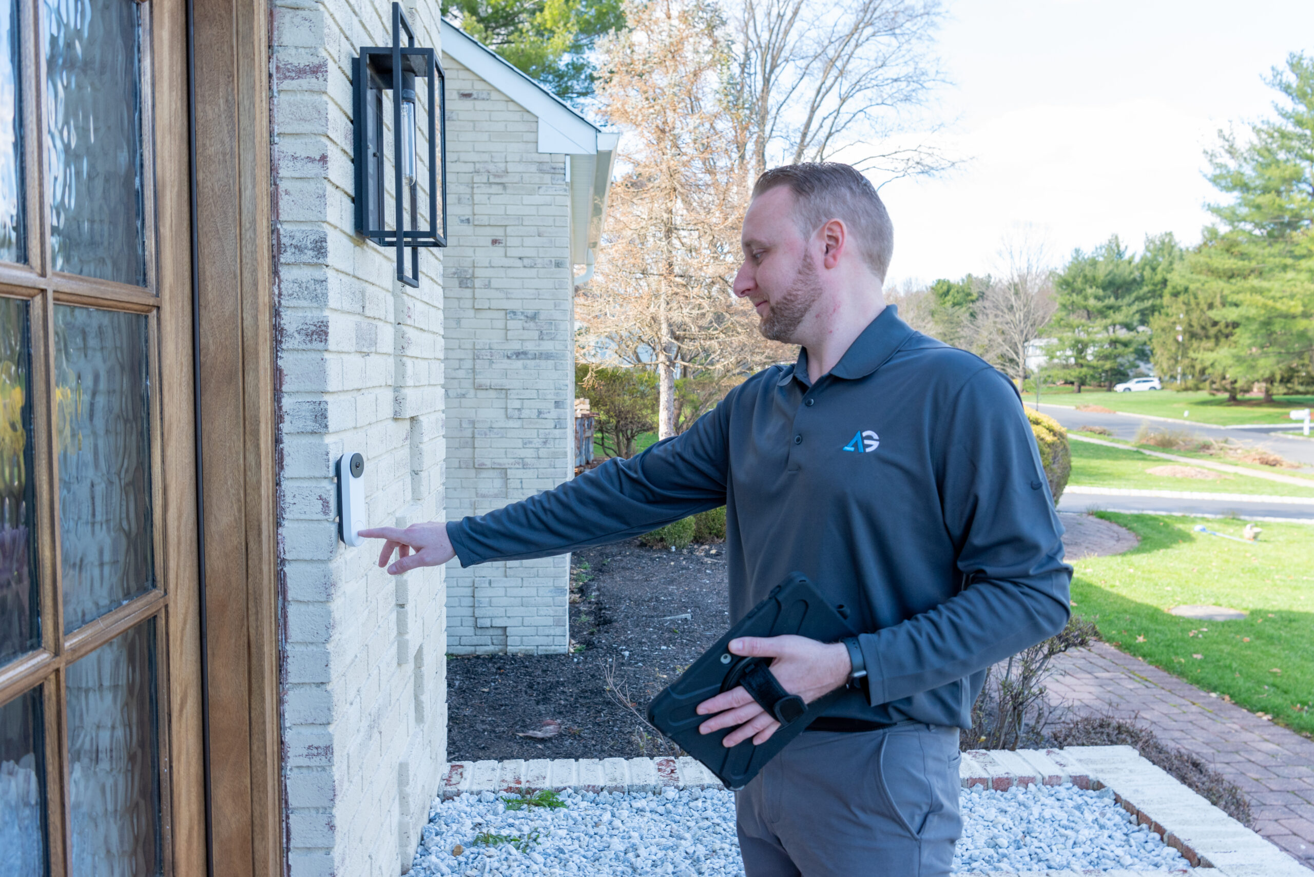 Agile Pest Control technician ringing a doorbell for a rodent control inspection at a home in Howell Township, NJ.