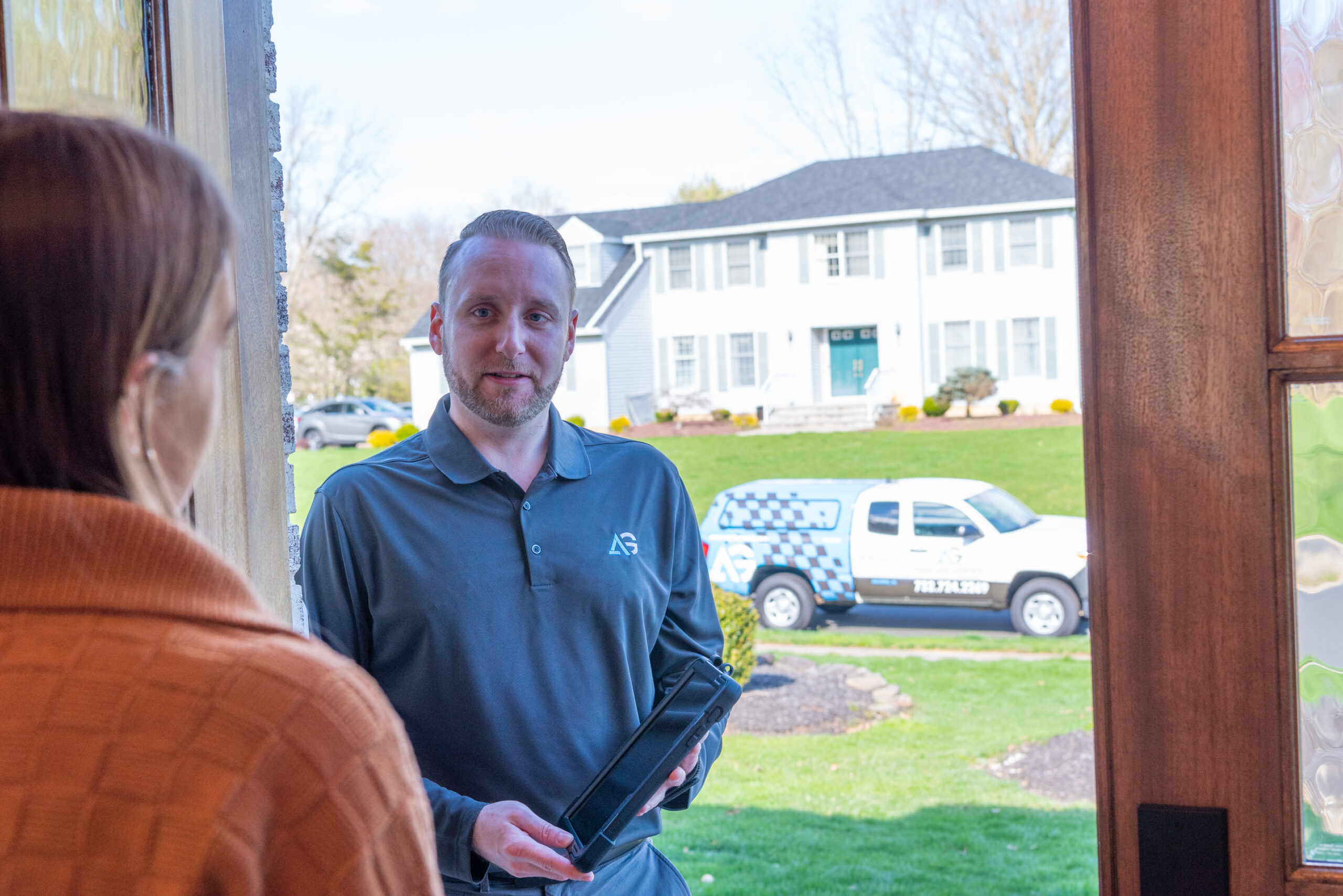 Agile Pest Control technician carefully reviewing a detailed bed bug control proposal with a homeowner in Brick, NJ, ensuring a tailored pest management solution that addresses the specific needs of the local property.