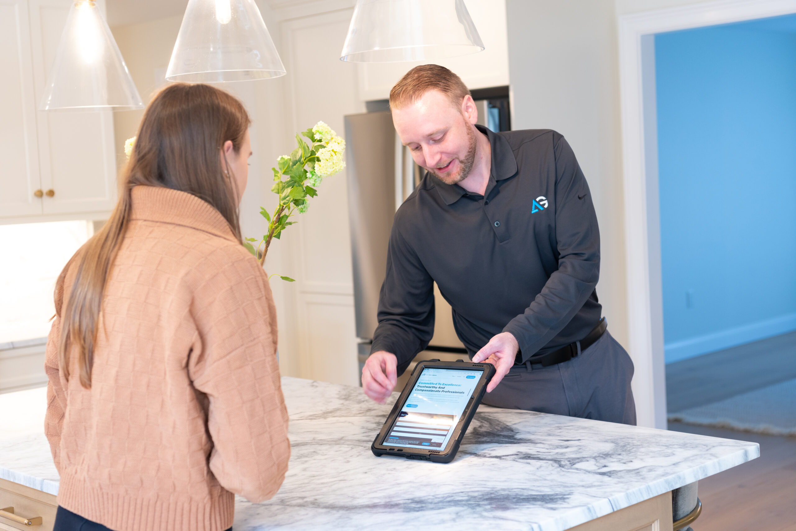 Agile Pest Control technician reviewing a detailed rodent control proposal with a homeowner inside a Manalapan, NJ residence, highlighting entry points and recommended treatments to ensure a rodent-free environment.