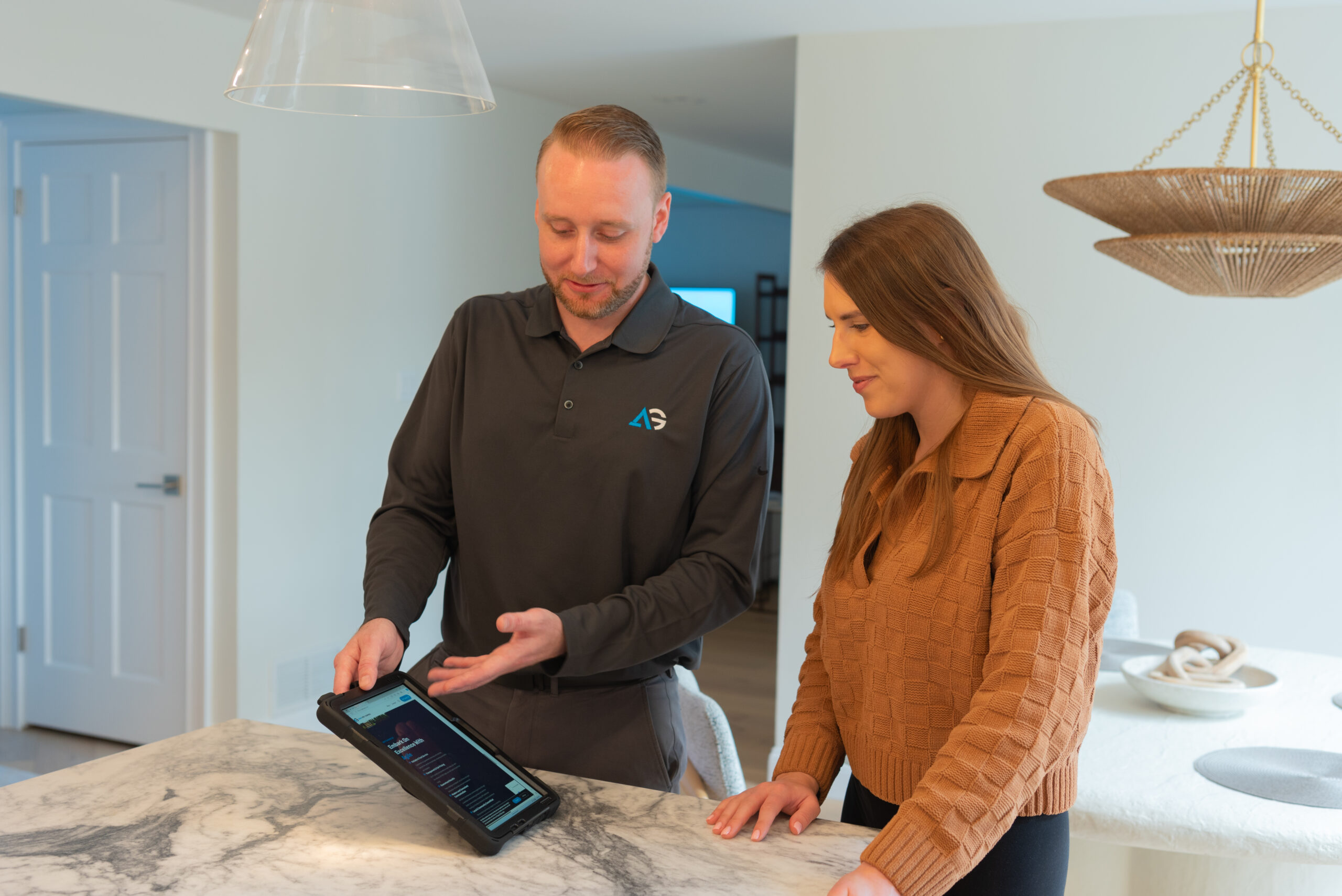 Agile Pest Control technician reviewing a detailed bed bug control proposal with a client at their home in Little Silver, NJ, discussing treatment options and next steps.