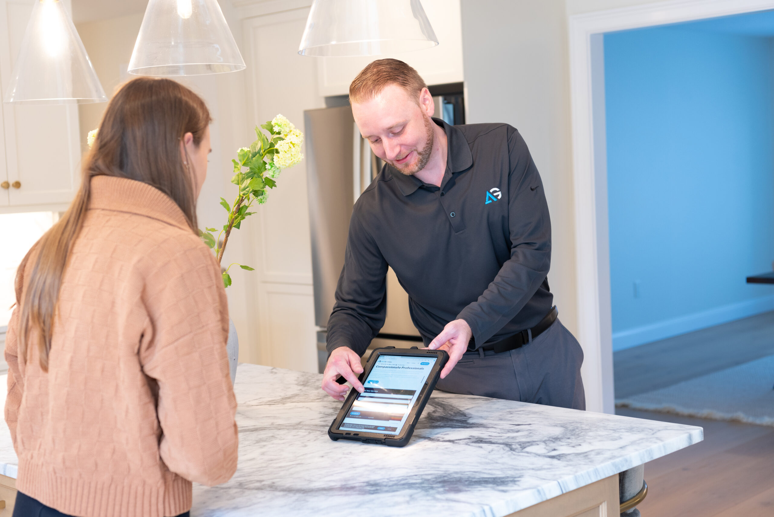 Agile Pest Control technician reviewing a detailed proposal for bed bug control with a customer in Manalapan, NJ, discussing treatment options and inspection results to ensure a pest-free home.