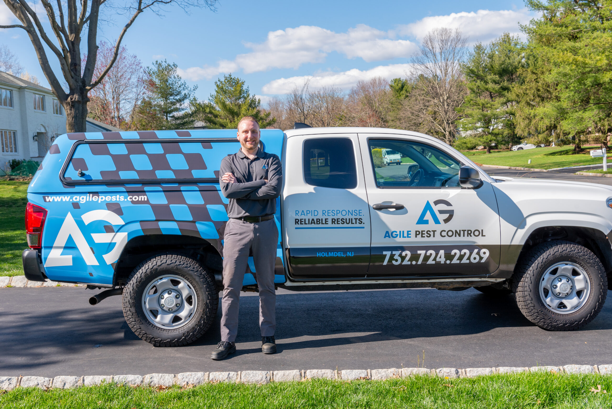 Agile Pest Control technician preparing for a bed bug inspection at a home in Marlboro, NJ. The technician, dressed in a professional uniform, is organizing inspection tools and equipment, ready to provide expert bed bug detection services for the local homeowner, ensuring a thorough and efficient inspection process.