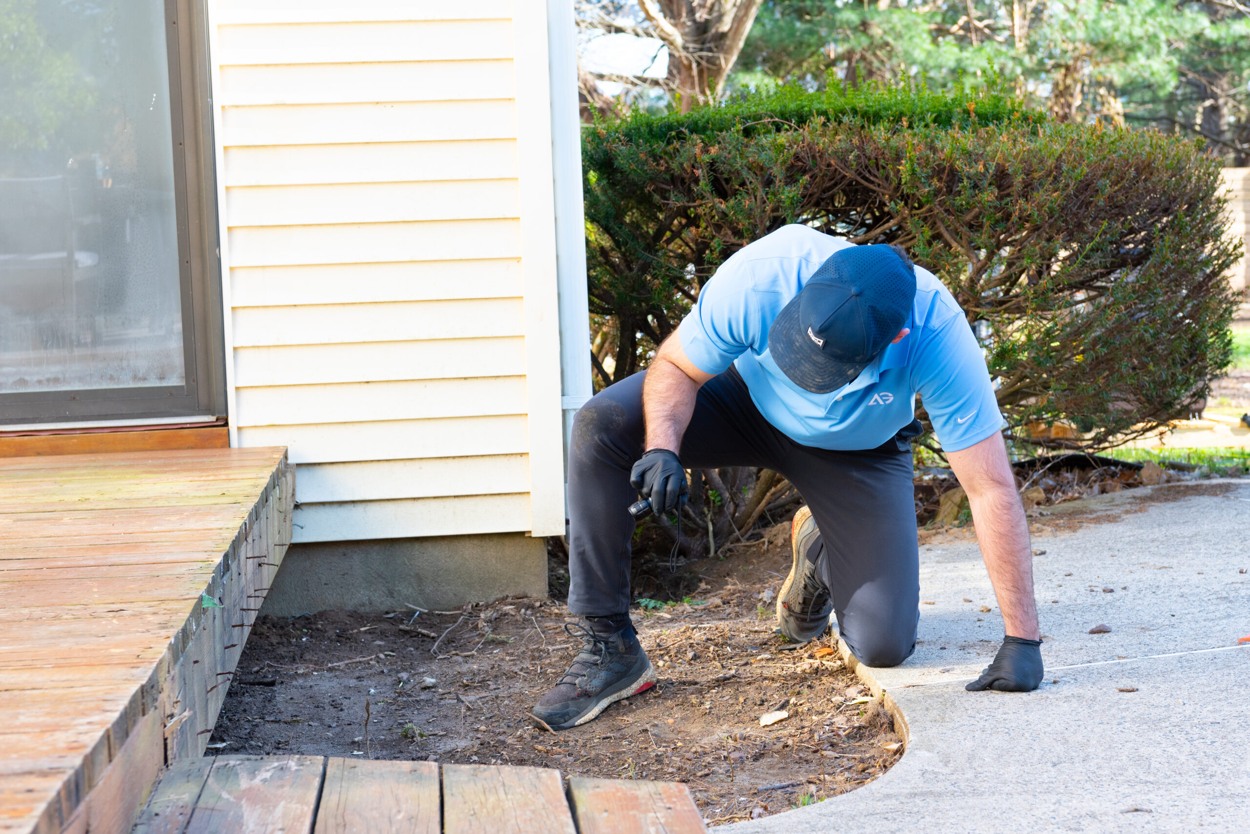 Agile Pest Control technician conducting a detailed inspection for mice control in a Monmouth County, NJ home