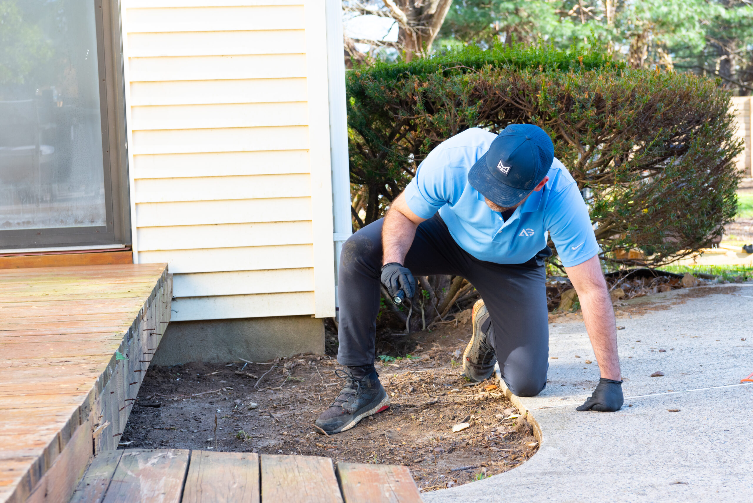 Agile Pest Control technician performing a detailed inspection for mice control in a Monmouth County, NJ property.