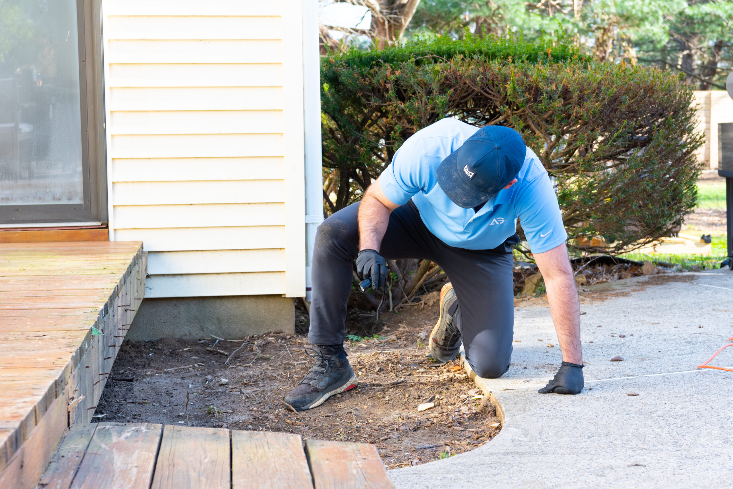 Agile Pest Control technician performing an inspection for rat exclusion in a Monmouth County, NJ property.