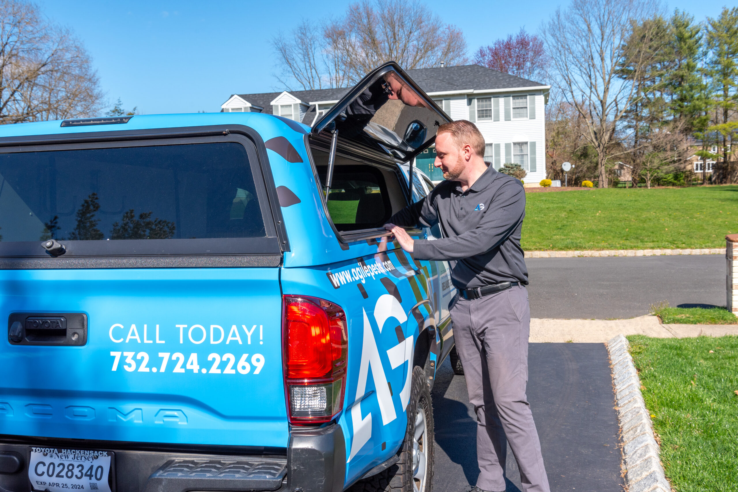 Agile Pest Control technician performing vole control services in Monmouth County, NJ, protecting lawns and gardens from vole damage.